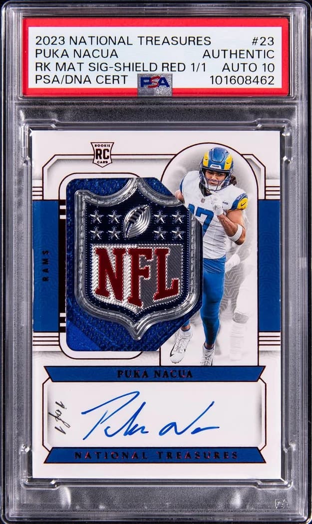 2023 Panini National Treasures Rookie Material Signatures Shield Red Puka Nacua #23 (1/1) card front